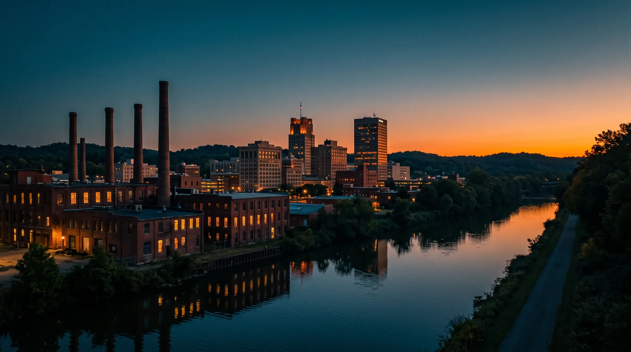 Akron, Ohio downtown and historic brick factory buildings along the river at dusk